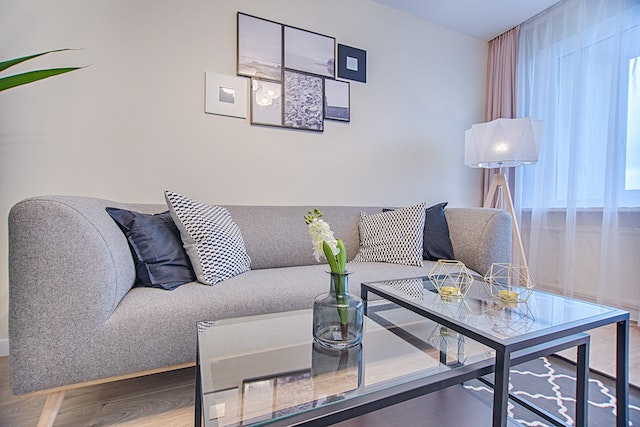 a-grey-couch-with-a-glass-table